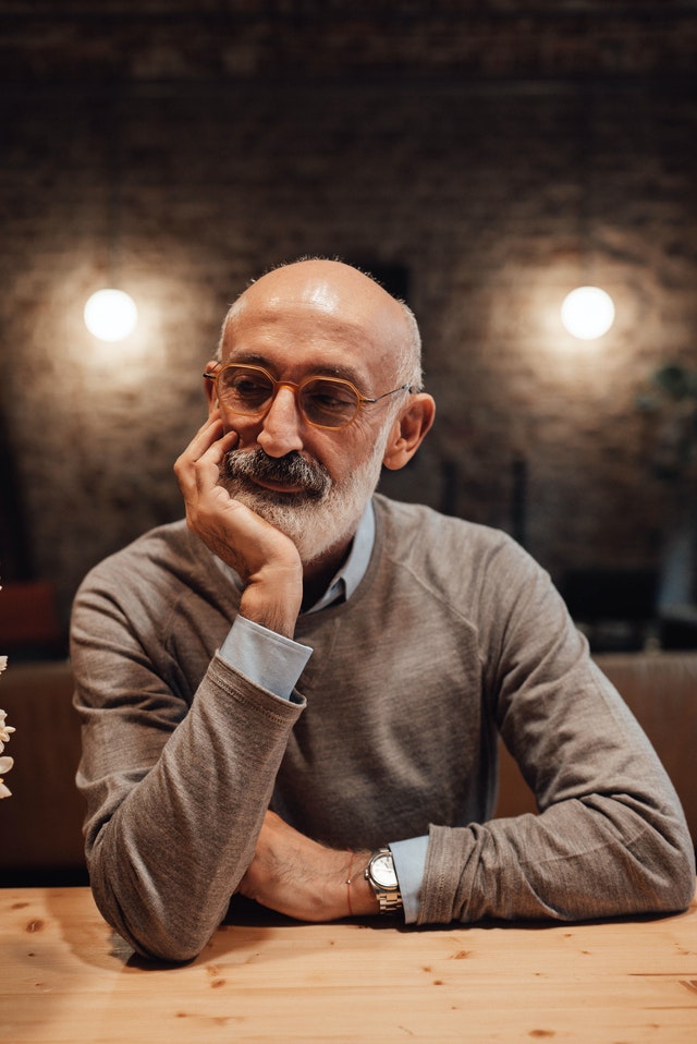 Man reflecting in a cafe